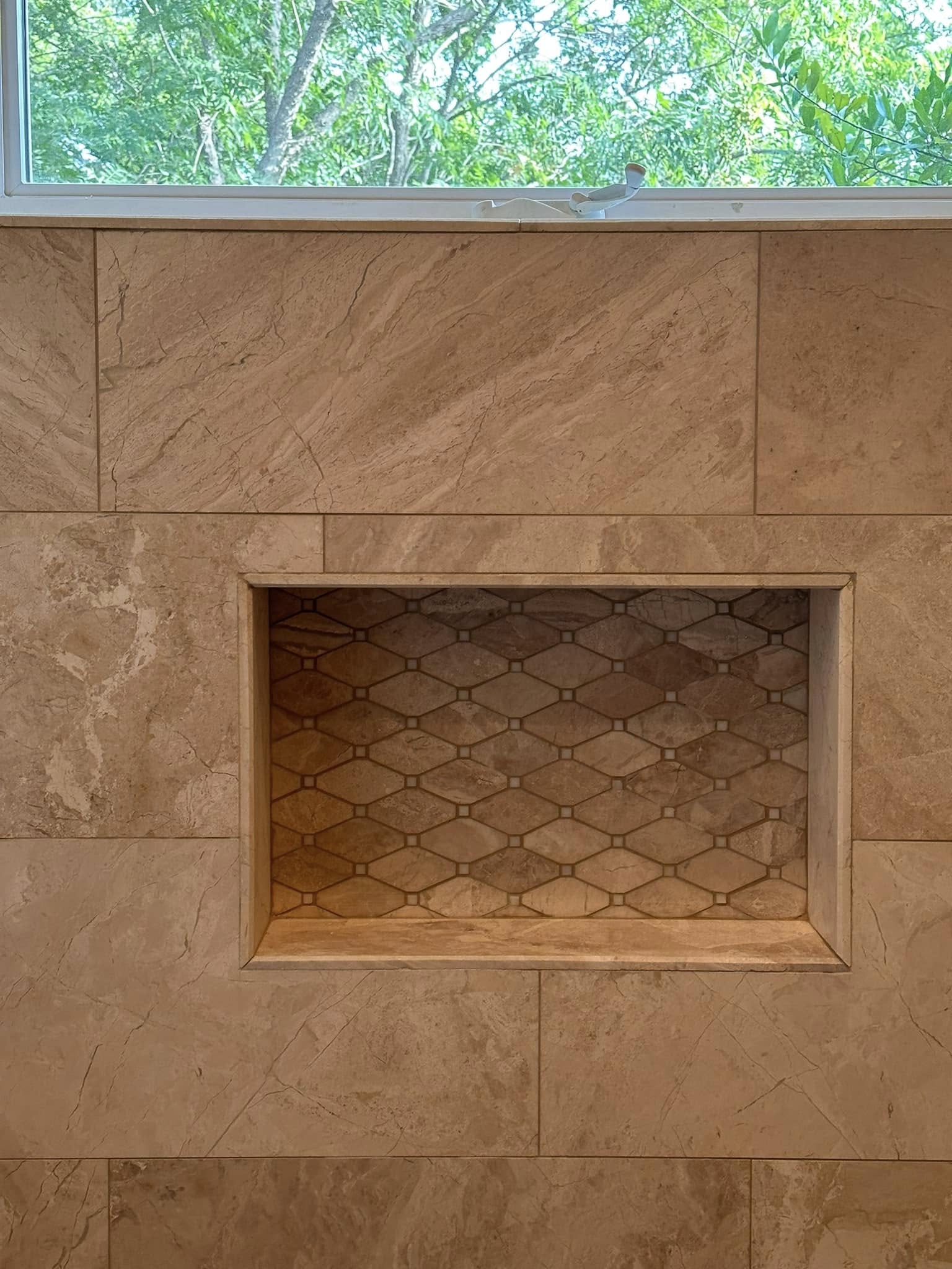 Shower remodel with marble herringbone tile